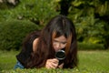 Pretty Asian woman with magnifying glass . Royalty Free Stock Photo
