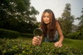 Pretty Asian woman with magnifying glass . Royalty Free Stock Photo