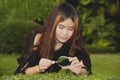 Pretty Asian woman with magnifying glass . Royalty Free Stock Photo