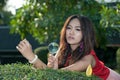 Pretty Asian woman with magnifying glass in the park . Royalty Free Stock Photo