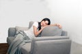 Asian woman relaxed and resting breathing fresh on sofa. Royalty Free Stock Photo