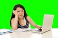 Pretty asian woman student overworked on her laptop on green screen croma key Royalty Free Stock Photo