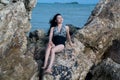 Pretty Asian woman in swimming suit posing on the beach. Royalty Free Stock Photo