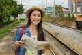 Pretty Asian woman travelling, waiting for the train with a smile. Royalty Free Stock Photo