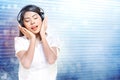 Pretty asian woman in white shirt listening music with headphones Royalty Free Stock Photo
