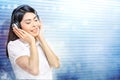 Pretty asian woman in white shirt listening music with headphones Royalty Free Stock Photo