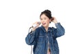 Pretty Asian young woman in jeans shirt holding microphone and singing isolated on white background. Beautiful woman smiles and Royalty Free Stock Photo