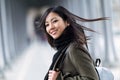 Pretty asian young woman smiling and looking at camera in the street. Royalty Free Stock Photo