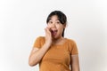 The pretty Asian young woman with surprise and shocked facial expression standing on a white background Royalty Free Stock Photo