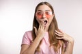 Pretty astonished, surprised girl covering her mouth over white background Royalty Free Stock Photo