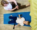 Pretty athletic mother and a young son play sports together at home. Healthy lifestyle Royalty Free Stock Photo