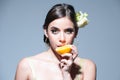 Pretty attractive funny comic positive woman having pieces of orange. Portrait of sexy sensual girl holding halves of