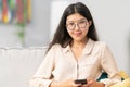 Pretty, attractive girl with perfect complexion, glasses, Asian beauty, smiles gently looking into the camera, dark hair Royalty Free Stock Photo