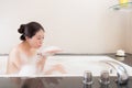 Pretty attractive woman sitting in bathtub bathing Royalty Free Stock Photo