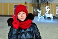 pretty attractive young girl in warm clothes, wearing red hat, scarf and gloves shows victory sign \