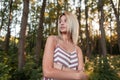 Pretty attractive young woman with blond hair with blue beautiful eyes with a sweet smile in a trendy summer striped sundress Royalty Free Stock Photo