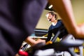 Pretty authentic female instructor with headset in fitness class exercise with group in cycling room Royalty Free Stock Photo