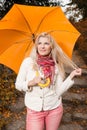 Pretty autumn woman in a forest with umbrella