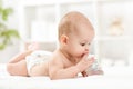 Pretty baby girl drinking water from bottle