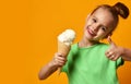 Pretty baby girl kid eating licking vanilla ice cream in waffles cone Royalty Free Stock Photo