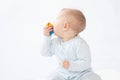 Pretty baby/infant plays with a toy Royalty Free Stock Photo