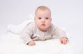 Pretty baby plays on the floor with a toy Royalty Free Stock Photo