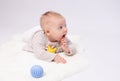 Pretty baby plays on the floor with a toy Royalty Free Stock Photo