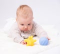 Pretty baby plays on the floor with a toy Royalty Free Stock Photo