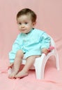 Pretty baby sitting on chamber-pot Royalty Free Stock Photo