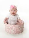 Pretty baby sitting in a hatbox Royalty Free Stock Photo