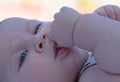 Pretty baby with thumb in its mouth Royalty Free Stock Photo