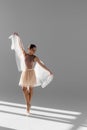 Pretty ballerina in beige skirt dancing