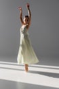 Pretty ballerina in dress spinning on