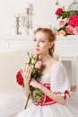 Pretty ballerina holding flowers