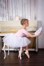 Pretty ballerina with notes in her hands