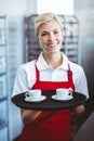 Pretty barista holding two cups of coffee Royalty Free Stock Photo