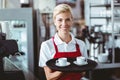 Pretty barista holding two cups of coffee Royalty Free Stock Photo