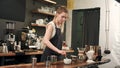 Pretty barista making coffee at cafe, pouring milk to a cup Royalty Free Stock Photo