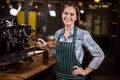 Pretty barista making coffee with coffee machine