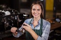 Pretty barista pressing coffee for coffee machine