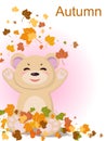 A pretty bear with a smile is pleased with the arrival of autumn and the fallen yellow leaves from the trees.