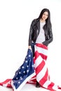 Pretty, beautiful, blak-haired woman with american flag wrapped around her