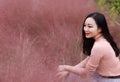 Pretty beautiful cute Asian Chinese woman girl feel freedom sweet dream pray flower field autumn fall park grass lawn hope nature Royalty Free Stock Photo