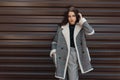 Pretty beautiful young brunette woman in a black t-shirt in a fashionable gray checkered jacket in vintage pants posing Royalty Free Stock Photo