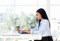 Pretty black businesswoman working working with laptop in modern office