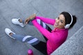 Pretty black woman resting after jogging outdoors Royalty Free Stock Photo