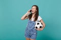 Pretty blinking young girl football fan with soccer ball talking on mobile phone, conducting pleasant conversation Royalty Free Stock Photo