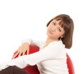 Pretty blond girl in red leather chair Royalty Free Stock Photo