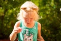 Pretty blond toddler girl making bubbles on a sunny summer day Royalty Free Stock Photo