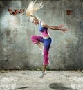 Pretty blond woman dancing in a grungy place